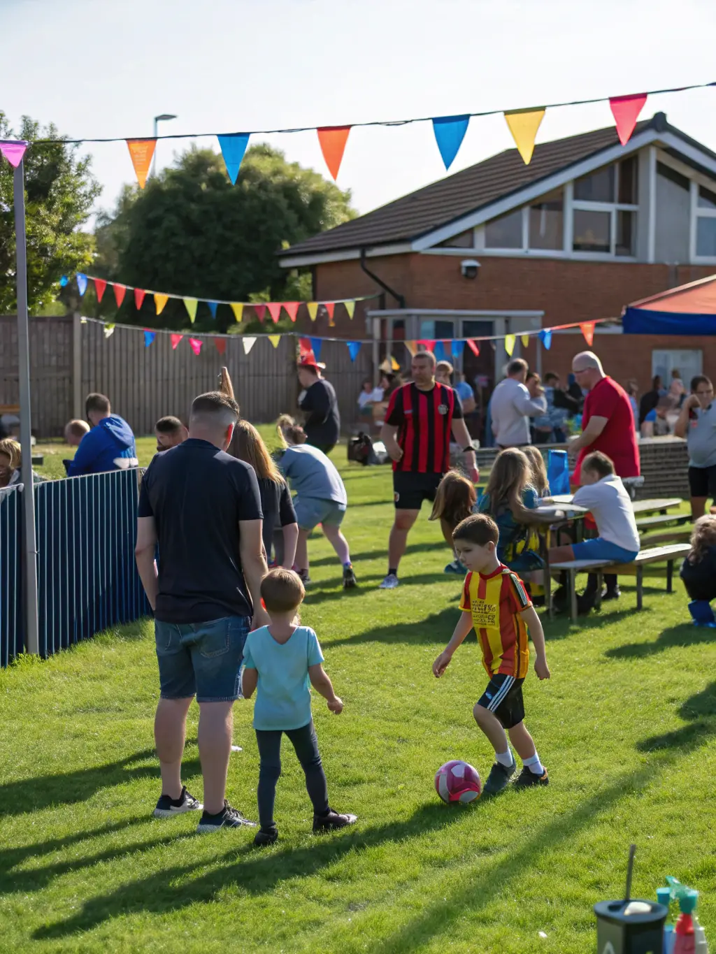 A community event organized by FOOTBALL CLUB DE L'ARTENSE, showing families and children participating in fun football-related activities and games.